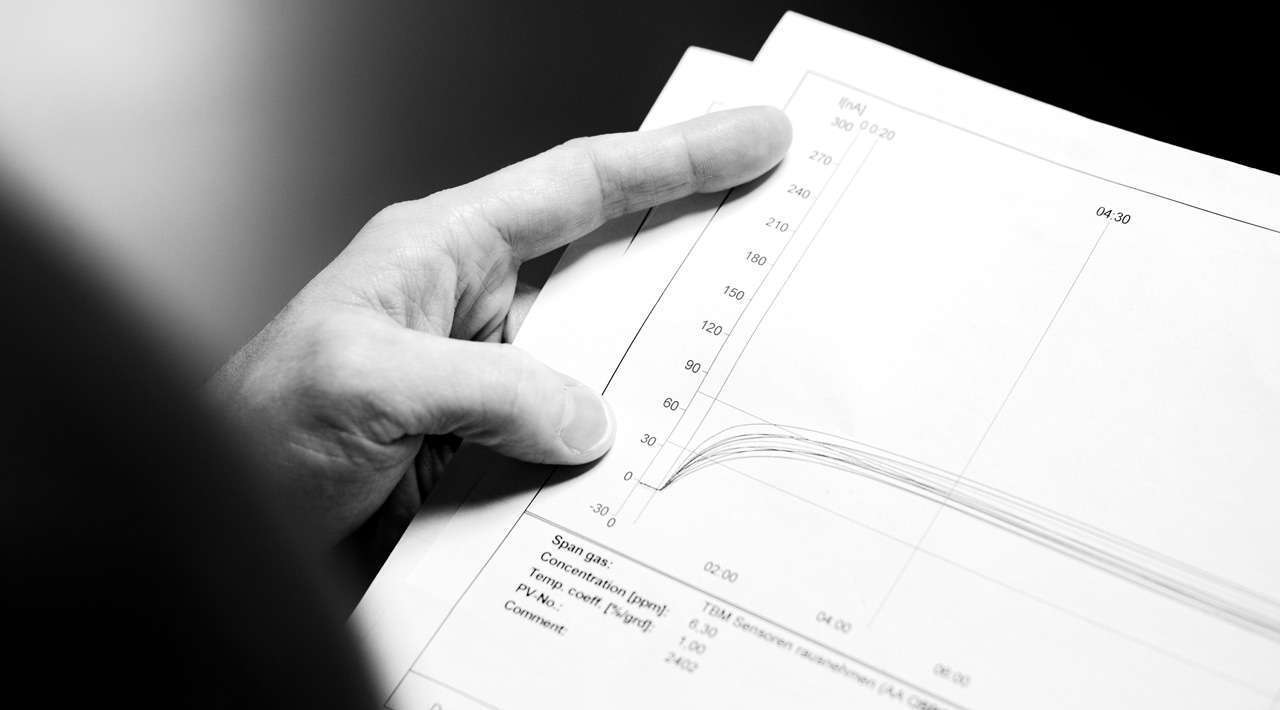 a photo of a man holding a print out of data